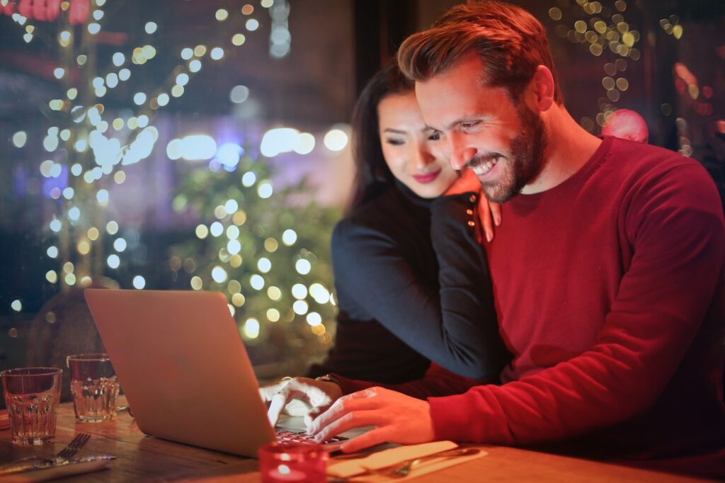 Couple looking at a laptop planning their finances with our financial advisor in Cork